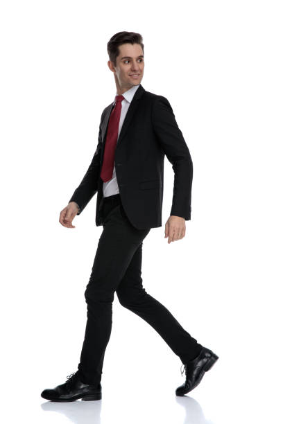 istock Side view of a curious businessman looking over his shoulder 1184000089