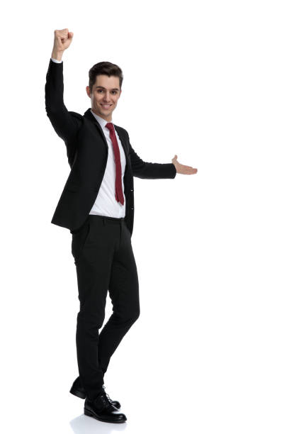 istock Positive young businessman presenting and celebrating 1184000195