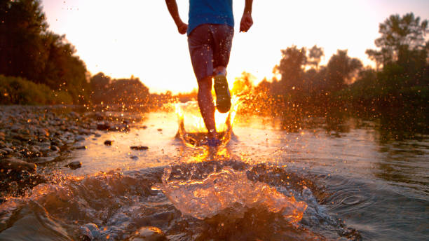 Sports concept with motionblur: Athlete trailrunning in the mountains during a nice sunset.