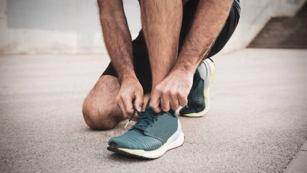 istock Tying sports shoes 1184003998