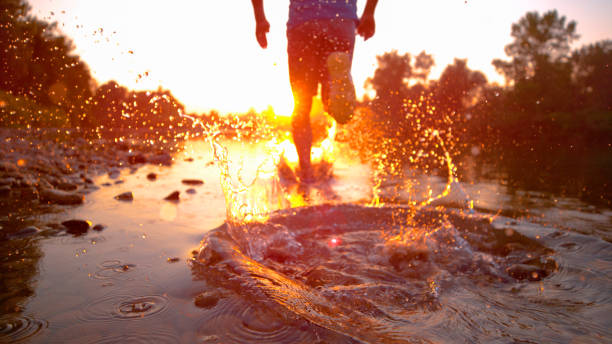 side view of sportive woman running and jumping, photo taken in morninf time near the sea side.