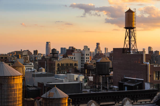 new york city summer sunset light on chelsea rooftops with water towers (manhattan), ny, usa - chelsea new york imagens e fotografias de stock