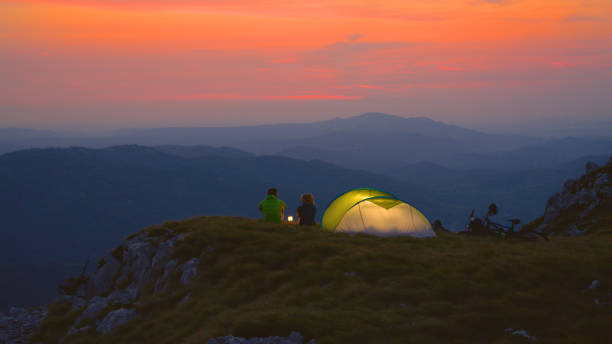 istock Active man and girlfriend talk during a romantic date in peaceful mountains. 1184004705