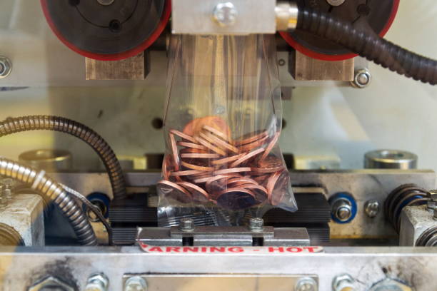 istock Coins manufactured and packed in money mint machine, steel galvanized with copper 1184004968