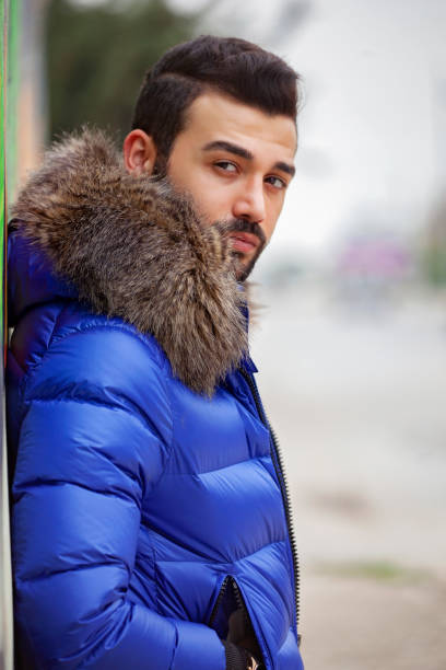 istock Young urban eskimo man with blue coat outdoors. 1184005750