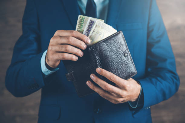 istock man hand  holding money with wallet 1184007666