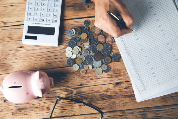 istock man hand coins with document and piggy bank on desk 1184007711