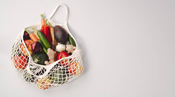 istock Fresh organic fruits and vegetables in mesh textile bag 1184007733
