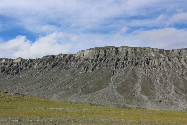 Altai dramatic landscape. Autumn mountains and clouds on sky.