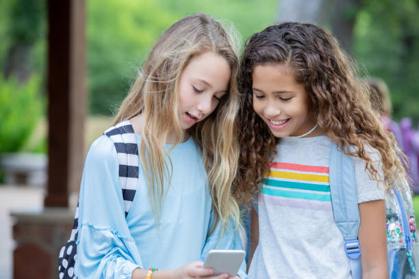 istock Pre teen girls using mobile phone 1184008823