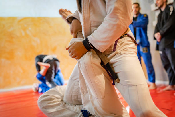 istock Leg drag technique on the brazilian jiu jitsu BJJ training class at the academy technique drilling sparring or warm up 1184009483