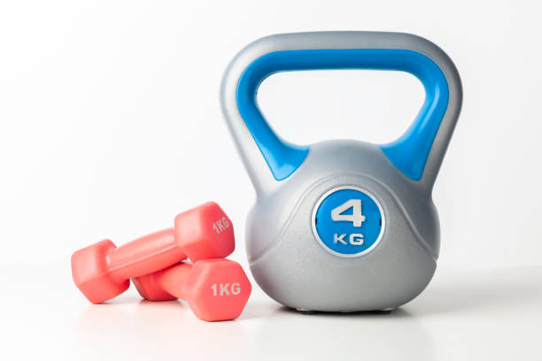 istock blue kettlebell and pink dumbbells 1184010266