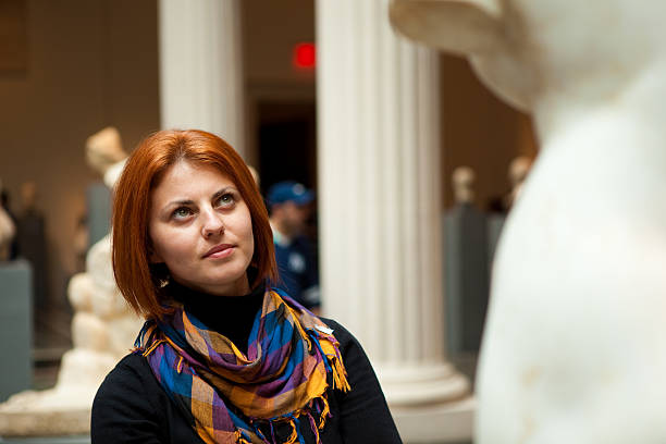 istock Woman in museum looking at fine art statue 118401099