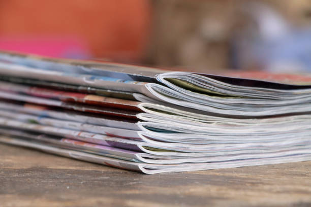 istock Colorful magazines on wooden table 1184012212