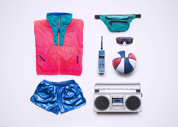 Nineties Basketball Fashion and Accessory Flat Lay Fluorescent windbreaker style clothing from the 1990's, along with accessories: fanny pack, brick phone, boombox, sunglasses, and basketball.  Knolling layout. 1990s style stock pictures, royalty-free photos & images