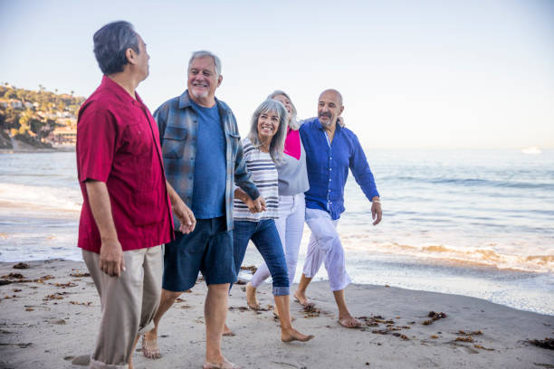 istock Five Best Friend Seniors Walking Along the Beach 1184013023
