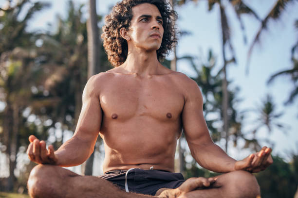 istock Man doing meditation exercises in nature 1184014052