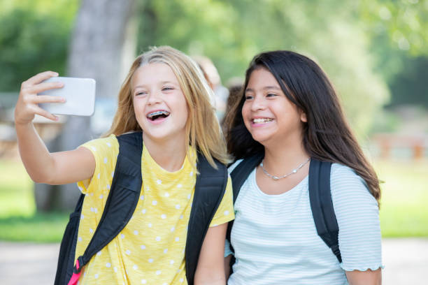 istock Two female student pose for selfie together 1184014248