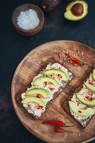 istock Preparing Vegetarian Avocado Pizza with Cottage Cheese and Chili 1184014962