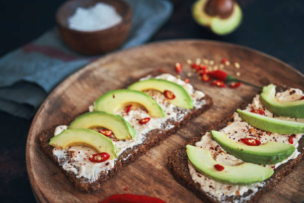 istock Preparing Vegetarian Avocado Pizza with Cottage Cheese and Chili 1184014974