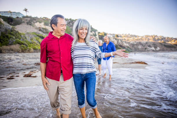 istock Senior Hispanic Couple Walking Along the Beach 1184015129
