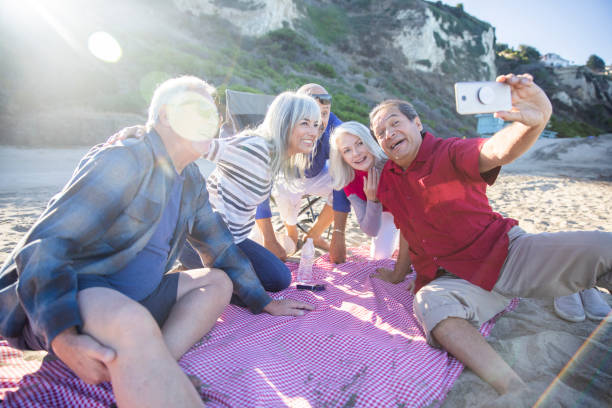 istock Senior Friends Taking Selfie at Picnic 1184015138