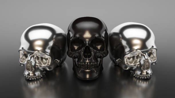istock Black and silver skulls sitting on the ground 1184015470