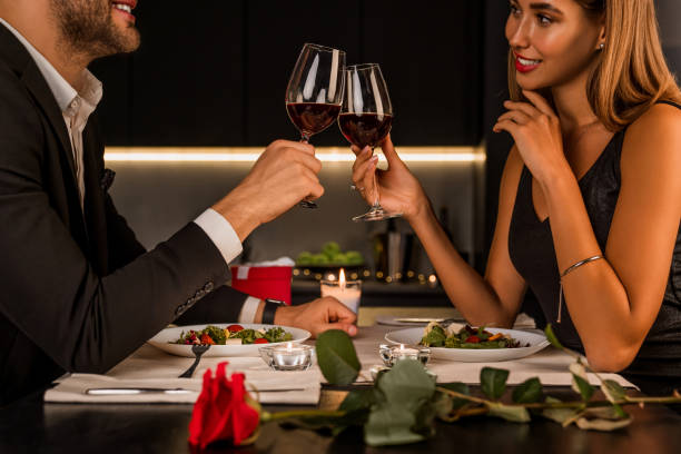 istock Happy couple toasting wineglasses at home kitchen 1184016518