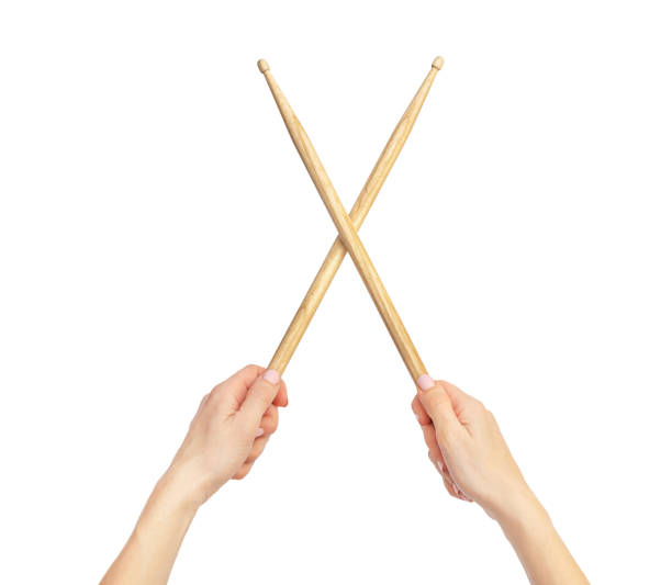 Woman's hands holding drum sticks. Isolated on white. Woman's hands holding drum sticks. Isolated on white. drummer hands stock pictures, royalty-free photos & images