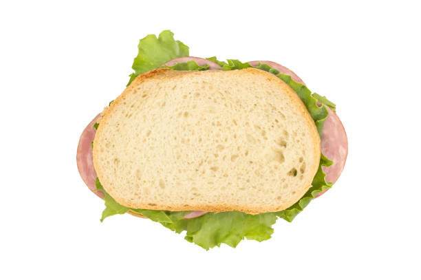 istock Sandwich with sausage and green lettuce on white. Top view. 1184016891