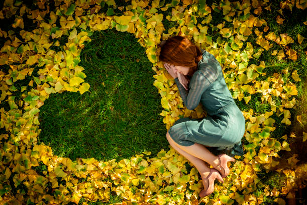 Beautiful woman and autumn ginkgo leaves stock photo