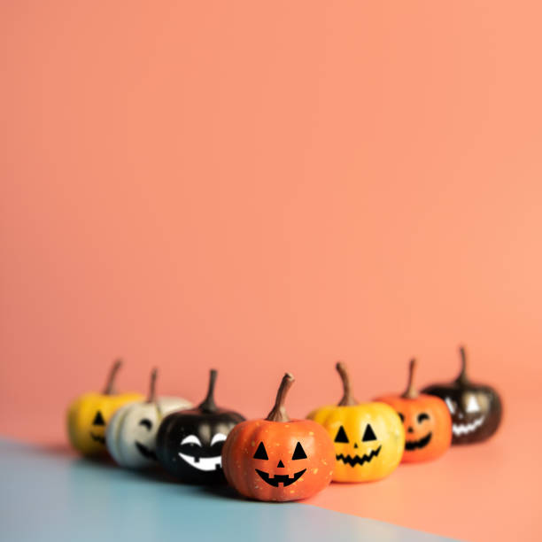 istock Halloween concept, Six Pumpkin with smile face on pastel colors background. 1184018331