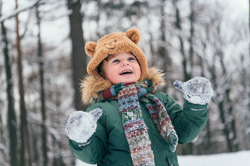 Excited child in winter forest