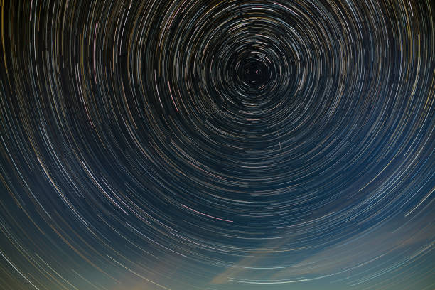 istock Star trail in the night sky with clouds. 1184020707