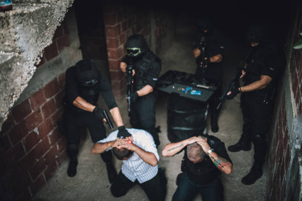 istock Police Arresting Gangster In Warehouse 1184020869