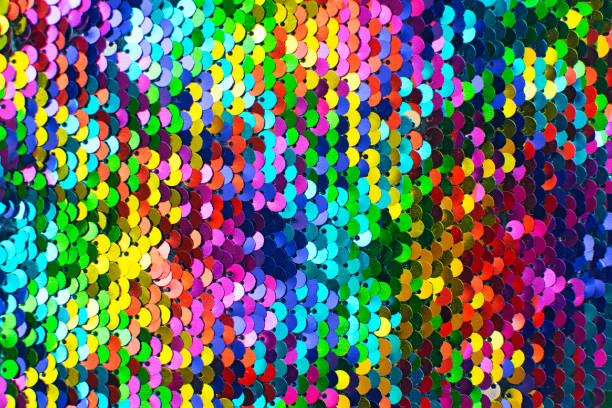Pieces of cloth with multi-colored sequins. Glitter background. Sequin texture. Texture of rainbow shiny sequins. Fashionable bright fabric with sequins. sequin stock pictures, royalty-free photos & images