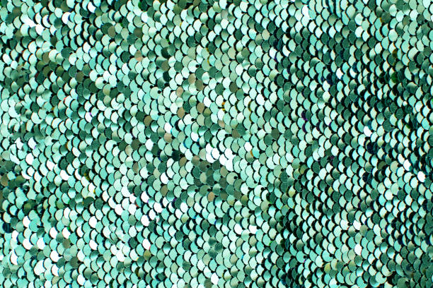 istock Pieces of cloth with neo mint sequins. Glitter background. Sequin texture. 1184022440