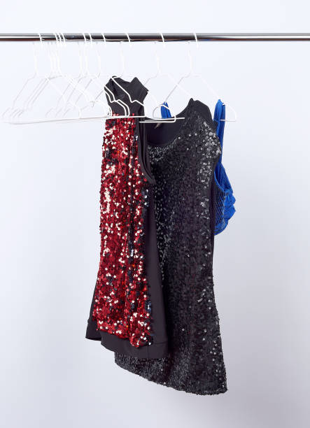 istock black women's blouses  with red and black sequins hanging on a white iron hanger 1184024210