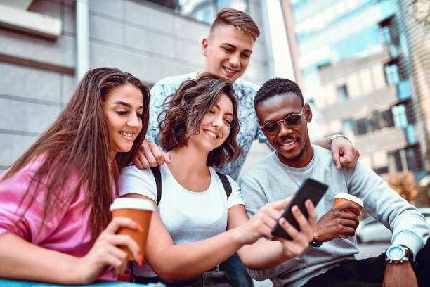 istock Multiethnic Group Of Students Looking At Class Schedule On Smartphone 1184025580