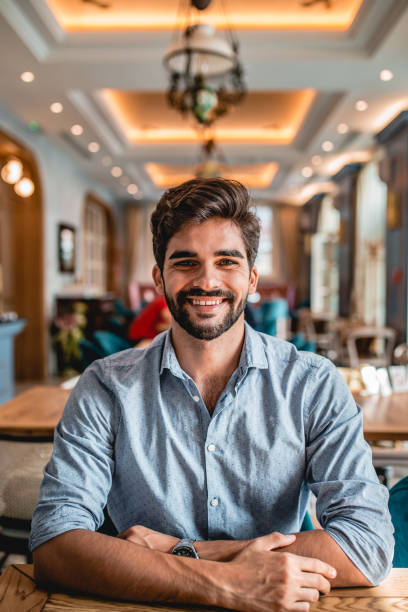 istock Portrait of a young man in a cafeteria 1184025665