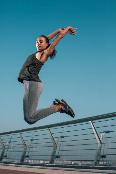 istock Active lady jumping high outdoors stock photo 1184026815