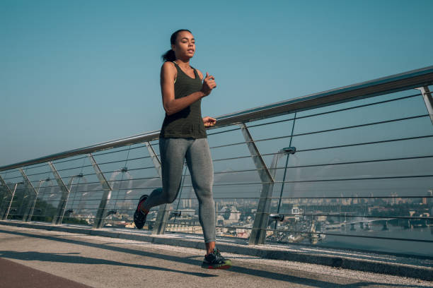 istock Healthy lady jogging outdoors alone stock photo 1184027143