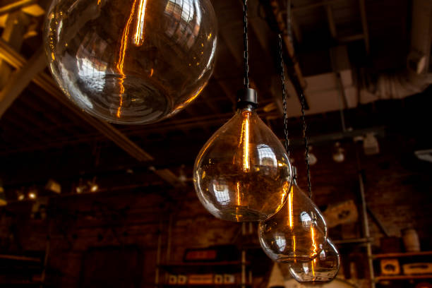 istock vintage large hanging glass lightbulbs with orange glow 1184032118