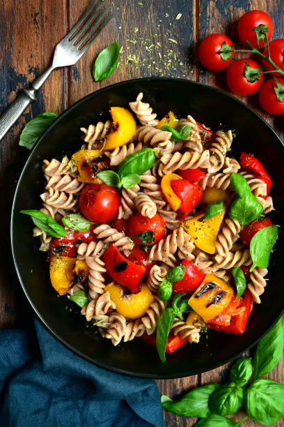 istock Whole wheat fusilli pasta with grilled vegetables 1184033360