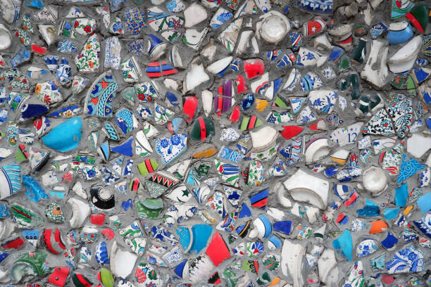istock Wall, decorated with broken pieces of handmade ceramic pots. 1184033643