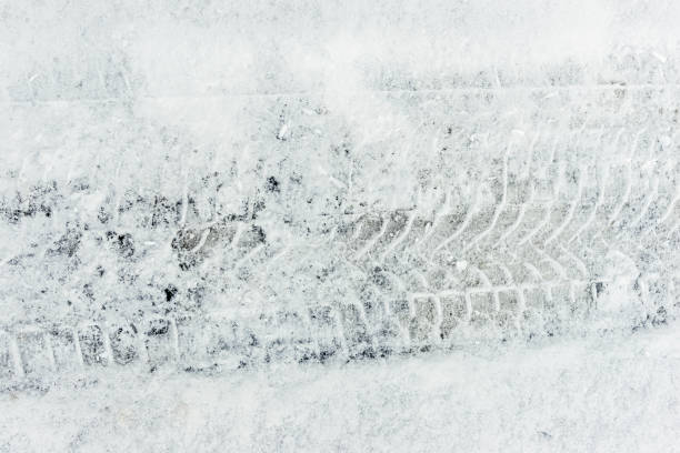 istock Tire tracks on the snowy ground under blizzard. 1184034037