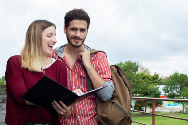 istock Two University students studying together outdoors 1184039531
