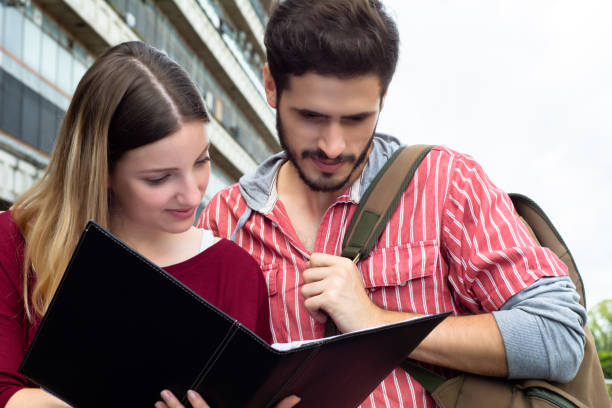 istock Two University students studying together outdoors 1184039532