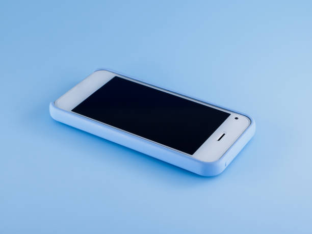 istock White phone in blue case on blue background 1184039760