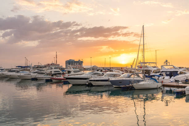 istock Yellow sunset in the sea harbor with moored yachts. 1184040596